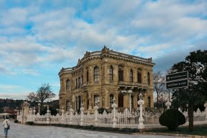 Elegant facade of Küçüksu Pavilion in Istanbul under a partly cloudy sky.