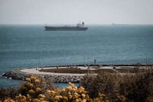 Cargo ship sailing in the Marmara Sea near Istanbul, Türkiye with a rocky coastline. Captures maritime activities.