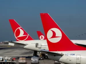Red-tailed Turkish Airlines planes on the tarmac at Istanbul Airport, showcasing travel and aviation.