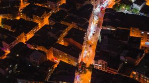 A vibrant aerial view of illuminated Istanbul streets and rooftops at night.