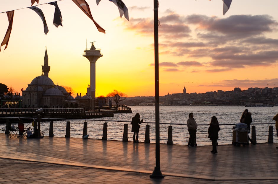 Captured at sunset, this tranquil view of İstanbul showcases the Bosphorus River and iconic skyline.